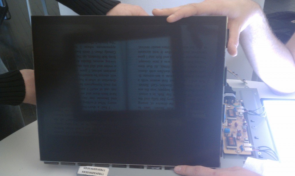 transparent lcd showing a book on the other side